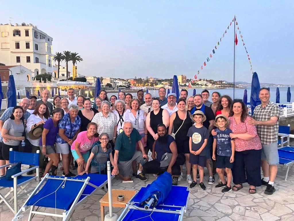 group photo of students traveling abroad on a pier. 