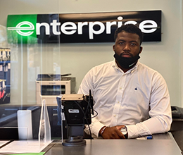 Thomas Michael working at his desk at Enterprise.